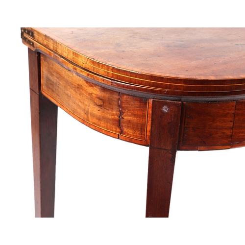 1009 - A 19th century mahogany card table on square tapering legs terminating in spade feet, 92cms wide.