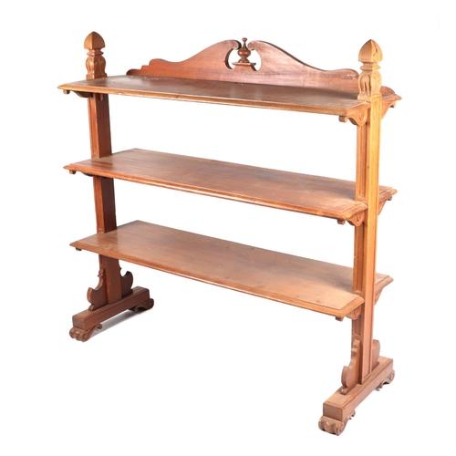 1020 - A Victorian walnut three-tier buffet with carved shaped end supports, 122cms wide.