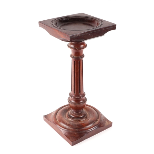 1021 - A carved mahogany candle stand with vase shaped reeded column, 18cms wide.