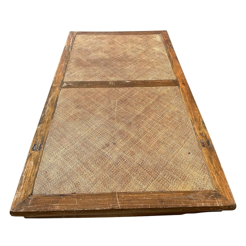 1030 - A large Indonesian teak and rattan low table / day bed, 225cms long by 124cms wide by 50cms high.