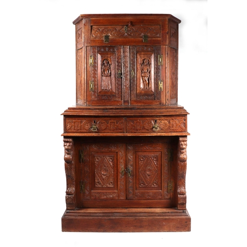 1035 - A 19th century carved oak cupboard, the superstructure with canted corners, the fall-flap frieze cup... 