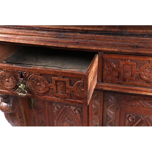 1035 - A 19th century carved oak cupboard, the superstructure with canted corners, the fall-flap frieze cup... 