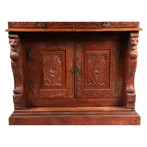 1035 - A 19th century carved oak cupboard, the superstructure with canted corners, the fall-flap frieze cup... 