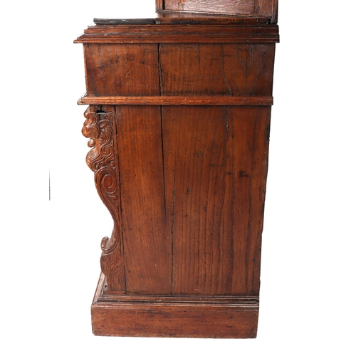 1035 - A 19th century carved oak cupboard, the superstructure with canted corners, the fall-flap frieze cup... 