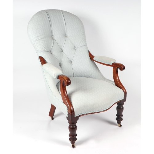 1038 - A Victorian mahogany button back armchair on turned front supports.