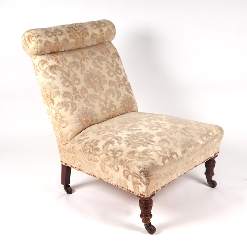 1039 - An Edwardian nursing chair with upholstered seat and back, on turned front supports.