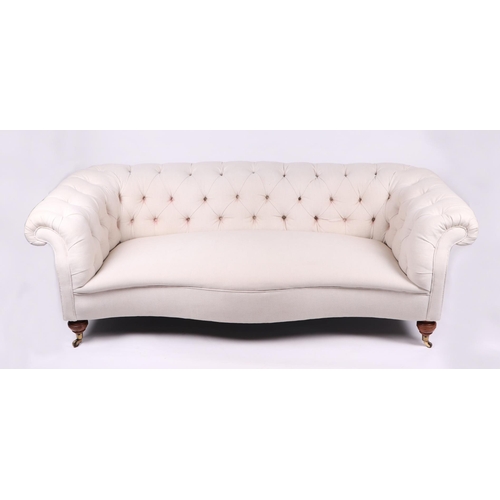 1043 - A Chesterfield cream upholstered three-seater  sofa on turned  front legs, approx 190cms wide.