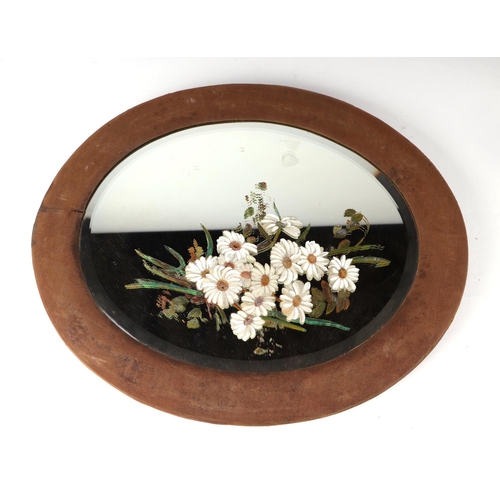 1070 - A Victorian oval wall mirror, the plate painted with flowers, in a fabric covered frame, 47 by 57cms... 