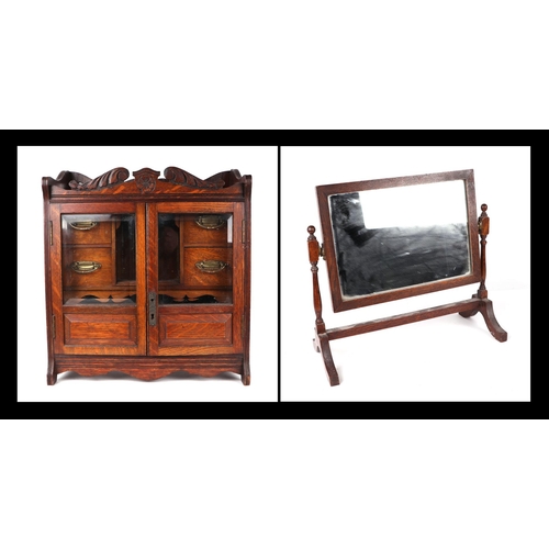 1074 - A late 19th century oak table top smoker's cabinet, the pair of glazed doors enclosing a fitted inte... 