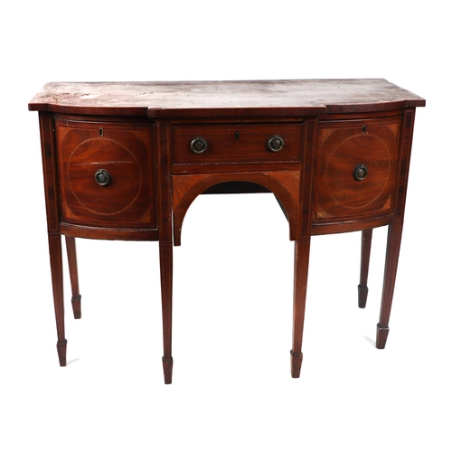 1075 - A George III mahogany breakfront sideboard of small proportions, the central door flanking two cupbo... 