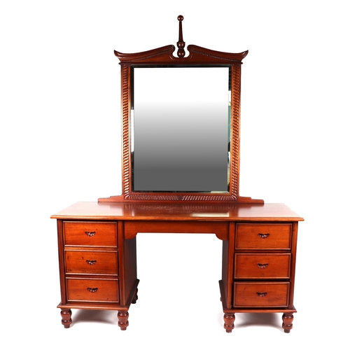 1079 - An American walnut kneehole twin pedestal dressing table or desk with bevelled mirrored back, with t... 