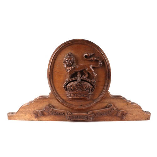 143 - A carved oak plaque - the Coat of Arms for the Royal Military College Sandhurst, 61cms wide.