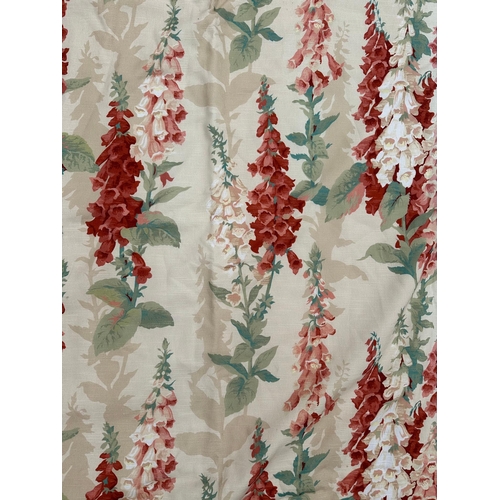 162 - A pair of lined curtains with hollyhock design, 270cms drop and 80cms wide.