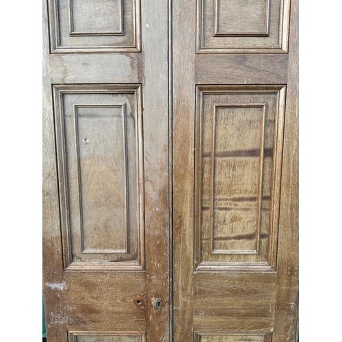 3 - A pair of large oak doors, each with three panels, both 208cms high and 48cms wide (2).