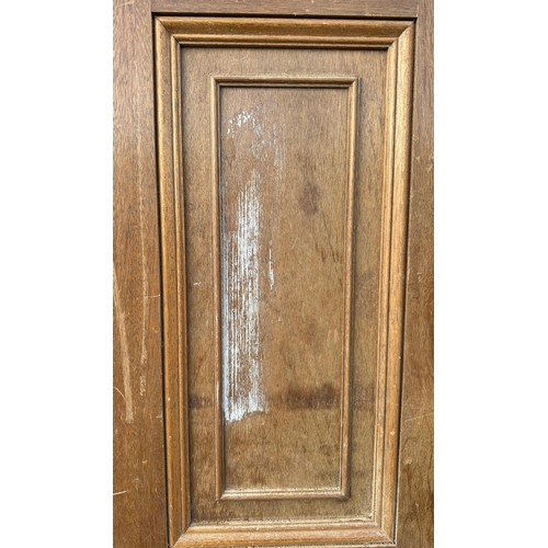 3 - A pair of large oak doors, each with three panels, both 208cms high and 48cms wide (2).