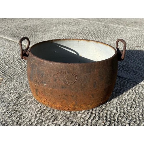 4 - A cast iron and enamel two-handled two-gallon cooking pot by Izons & Co., 34cms wide.