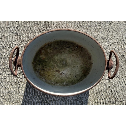 4 - A cast iron and enamel two-handled two-gallon cooking pot by Izons & Co., 34cms wide.