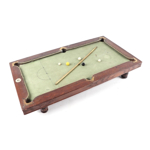 475 - An Edwardian NUKU miniature oak framed slate bed billiards table with adjustable feet, brass mounted... 