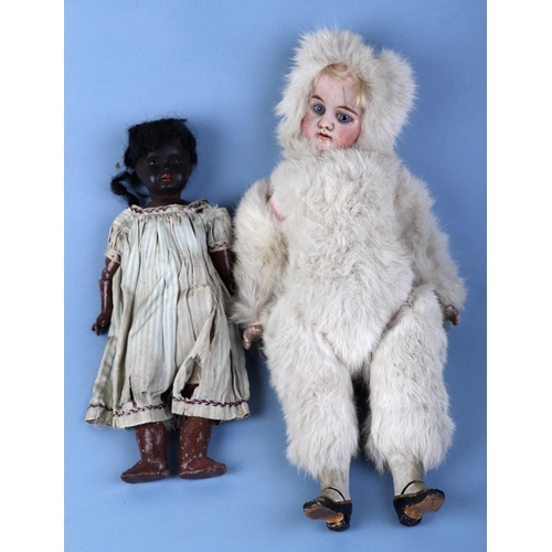 479 - A 19th century Eskimo 'Snow Baby' doll with bisque head and open blue eyes, 40cms high (legs detache... 