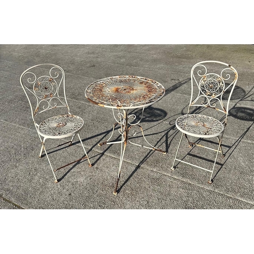 6 - A distressed painted metal garden patio set comprising circular table and two folding chairs (3).