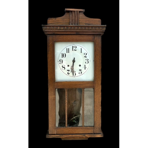 603 - An early 20th century oak cased wall clock, the silver dial with Arabic numerals, 75cm high.