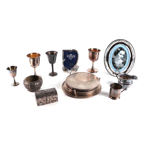 643 - A quantity of assorted silver plated items to include a candlestick, cream jugs, footed bowl, goblet... 