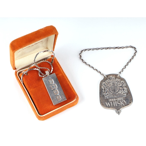 675 - A modern silver ingot pendant, 59g, London 1977; together with a Queen Elizabeth II limited edition ... 