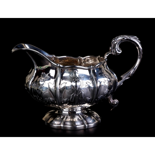 684 - A George IV silver milk jug decorated with flowers and foliate sprays, London 1825 and maker's mark ... 