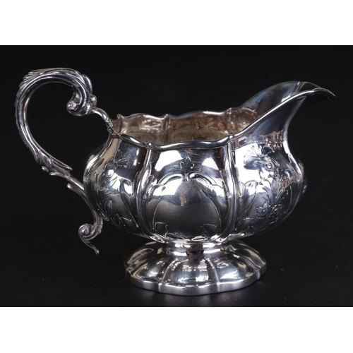 684 - A George IV silver milk jug decorated with flowers and foliate sprays, London 1825 and maker's mark ... 