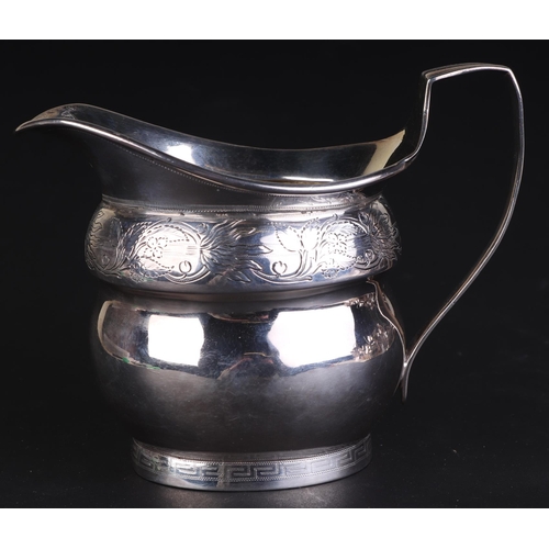 685 - A George III silver milk jug with foliate scrolls and Greek key decoration, London 1805 and maker's ... 