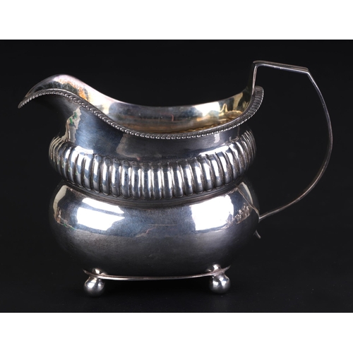 686 - A George III silver milk jug, London 1812 and maker's mark for Thomas Daniell, 9.5cms high, 153g.