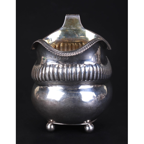 686 - A George III silver milk jug, London 1812 and maker's mark for Thomas Daniell, 9.5cms high, 153g.