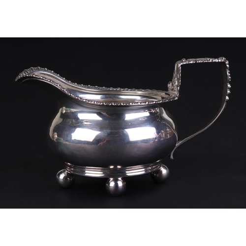 687 - A George III silver cream jug, London 1815 and maker's mark for Robert Hennell, 8cms high, 211g.