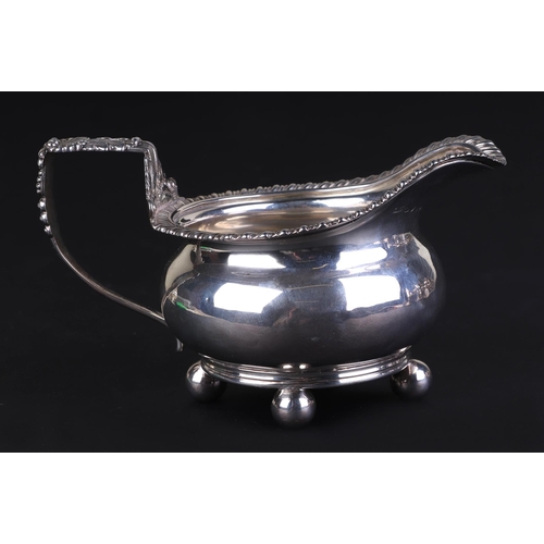 687 - A George III silver cream jug, London 1815 and maker's mark for Robert Hennell, 8cms high, 211g.