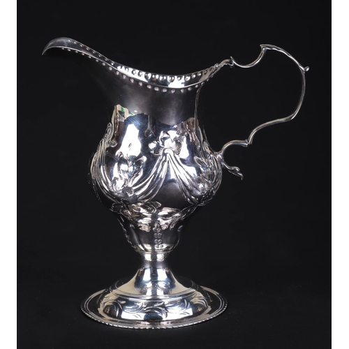 696 - A George III silver cream jug, London 1786 and maker's mark for Charles Hougham, 11cms high, 75g.