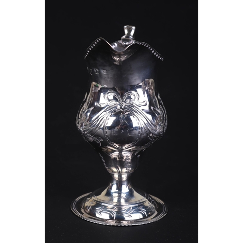 696 - A George III silver cream jug, London 1786 and maker's mark for Charles Hougham, 11cms high, 75g.