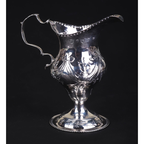 696 - A George III silver cream jug, London 1786 and maker's mark for Charles Hougham, 11cms high, 75g.