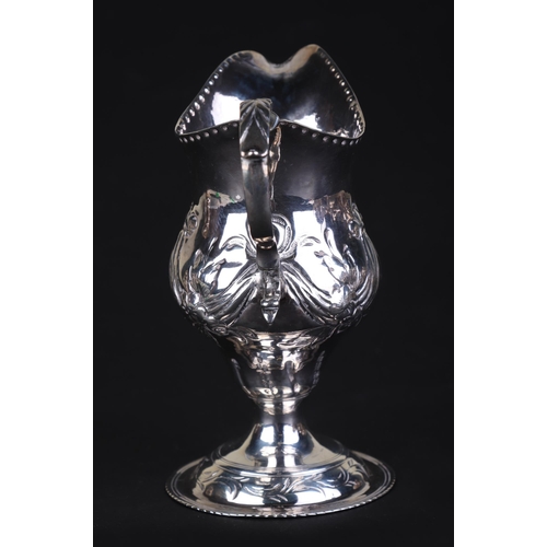 696 - A George III silver cream jug, London 1786 and maker's mark for Charles Hougham, 11cms high, 75g.