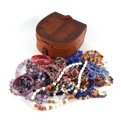 779 - A quantity of assorted vintage costume jewellery to include bead necklaces and bangles, contained wi... 