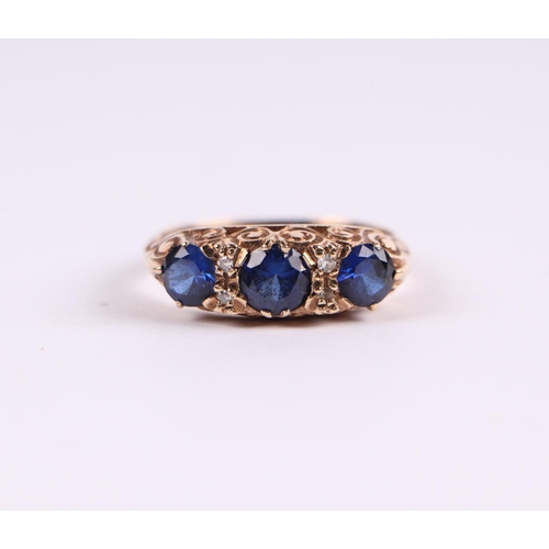 798 - A 9ct gold ring set with three large sapphires interspersed with diamonds, approx UK size 'M'.