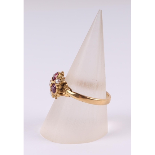 808 - An 18ct gold dress ring set with three pale pink stones and seed pearls, approx UK size N, 2.9g.