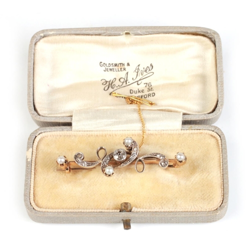 814 - A yellow metal (tests as 18ct) diamond and pearl bar brooch, boxed, 4.5cms wide, 5.6g.