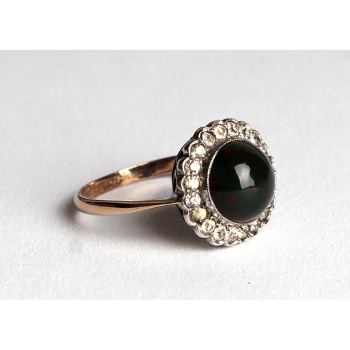 822 - A 9ct gold ring set with a bloodstone cabochon surrounded by with white stones, approx UK size M, 2g... 