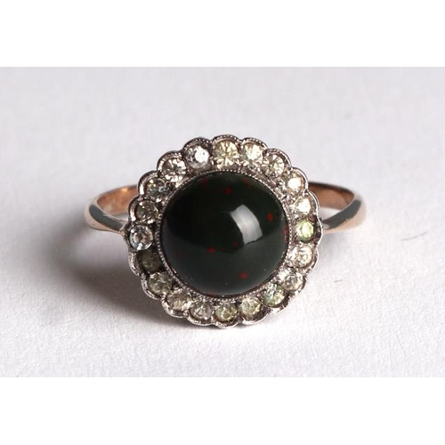 822 - A 9ct gold ring set with a bloodstone cabochon surrounded by with white stones, approx UK size M, 2g... 