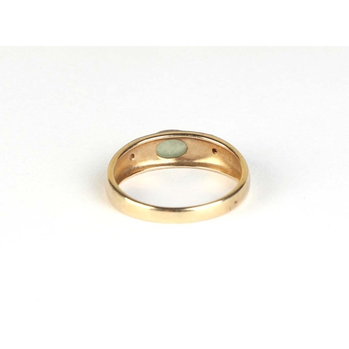 826 - A 9ct gold ring set with an oval jade cabochon, approx UK size Q, 2.7g.