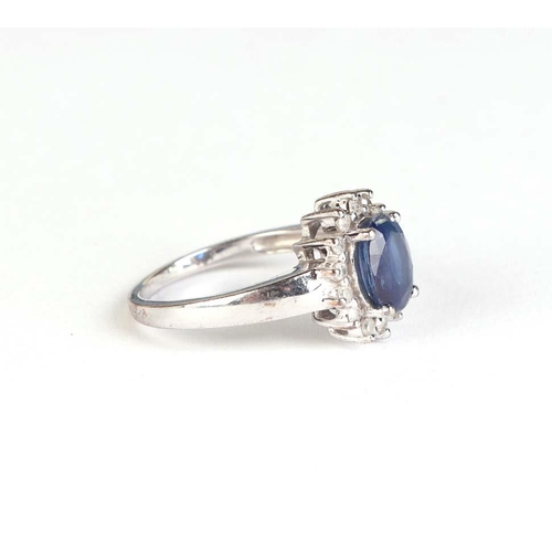 827 - A 9ct white gold tanzanite and diamond cluster ring, approx UK size L, 3.6g.