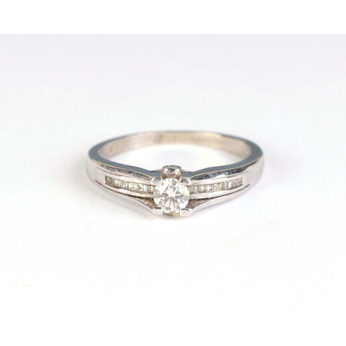 830 - A 9ct white gold modern design ring set with a central diamond and diamond set shoulders, approx UK ... 