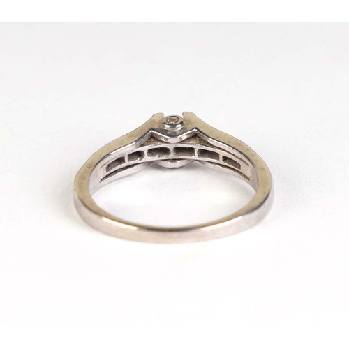 830 - A 9ct white gold modern design ring set with a central diamond and diamond set shoulders, approx UK ... 