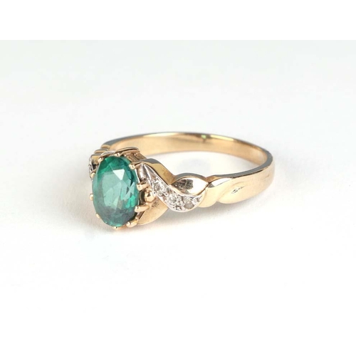 831 - A 9ct gold ring set with a central oval green stone (possibly emerald) and diamond set shoulders, ap... 