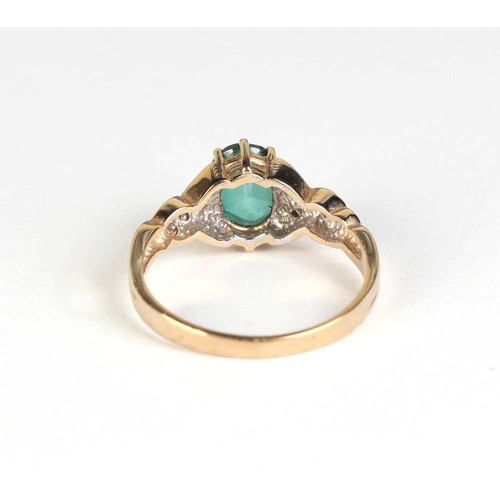 831 - A 9ct gold ring set with a central oval green stone (possibly emerald) and diamond set shoulders, ap... 